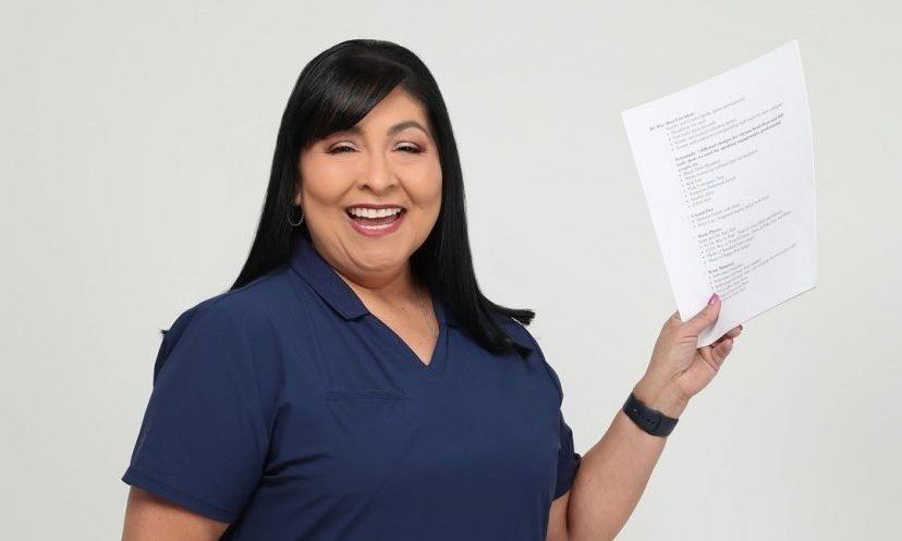 Women Smiling holding a paper